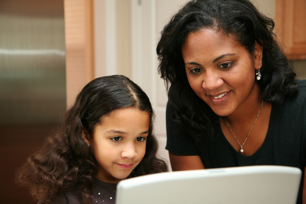 Student and guardian working at a notebook computer
